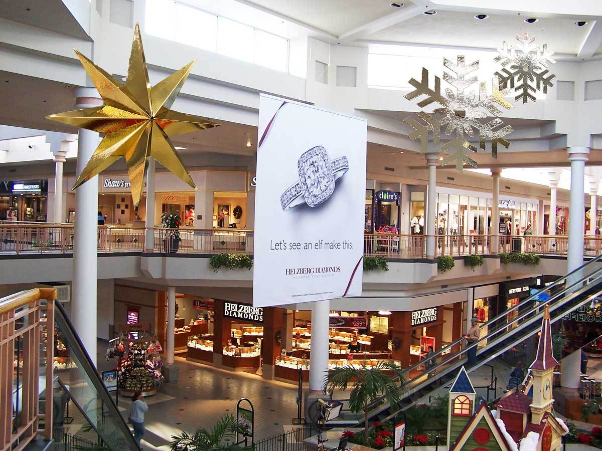 Custom designed holiday 4-d accent stars and snowflakes hanging from the mall ceiling