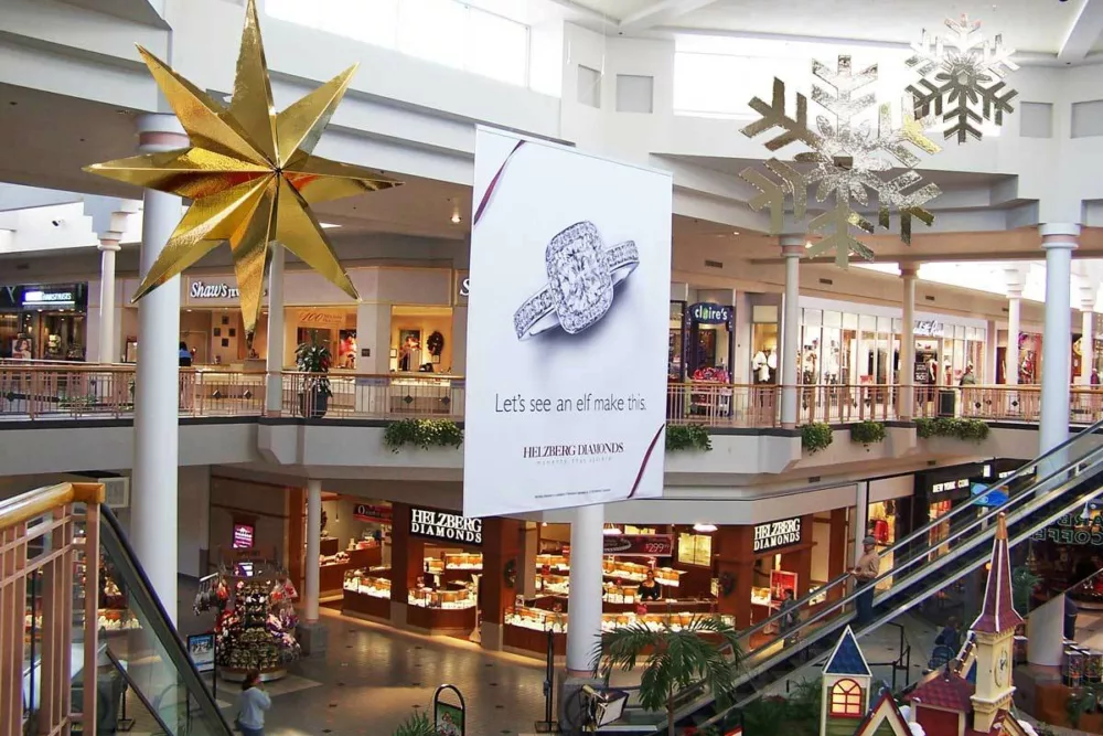 Custom designed holiday 4-d accent stars and snowflakes hanging from the mall ceiling