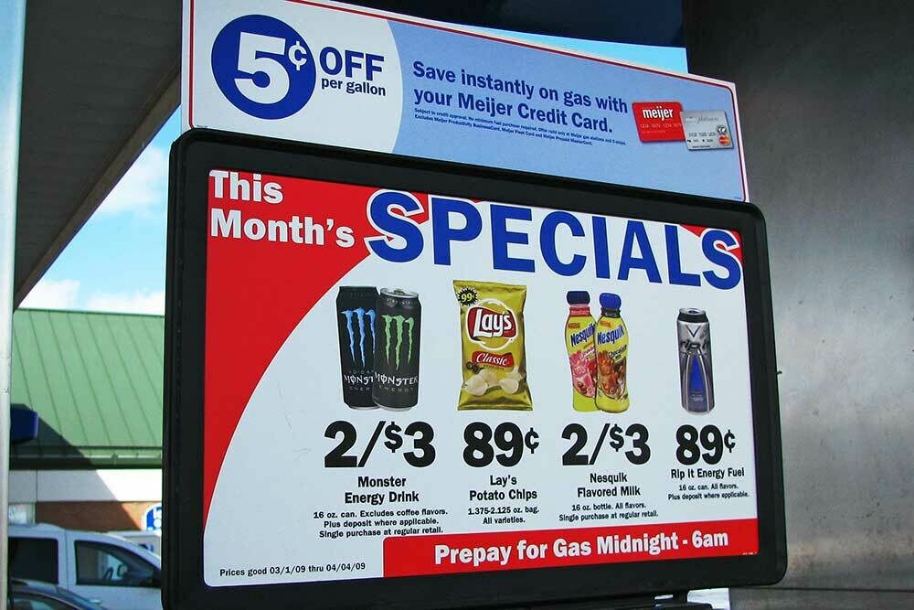 Rigid point of sales signs at a Meijer gas station pump