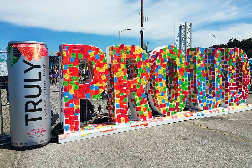 Foam 3d letteres that spell Proud and a life-sized Truly can