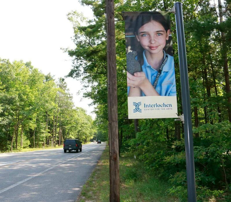 A light pole banner for Interlochen Arts Academy with a student on it