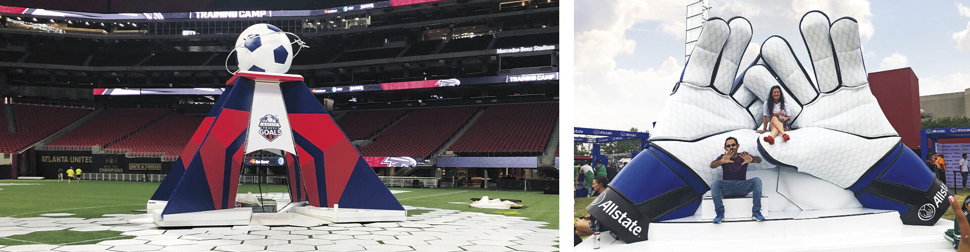Large foam sculptures of large goalie gloves and sponsorship logos at a soccer field.