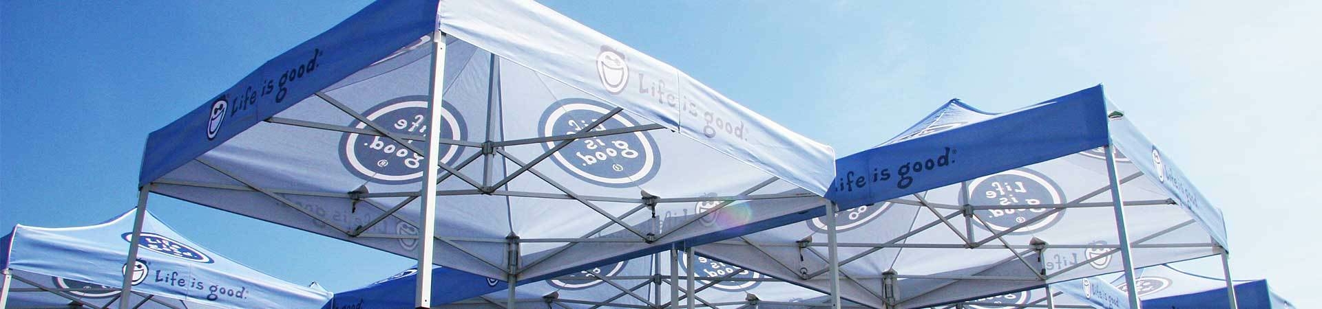 Custom printed tents from the underside at an event.