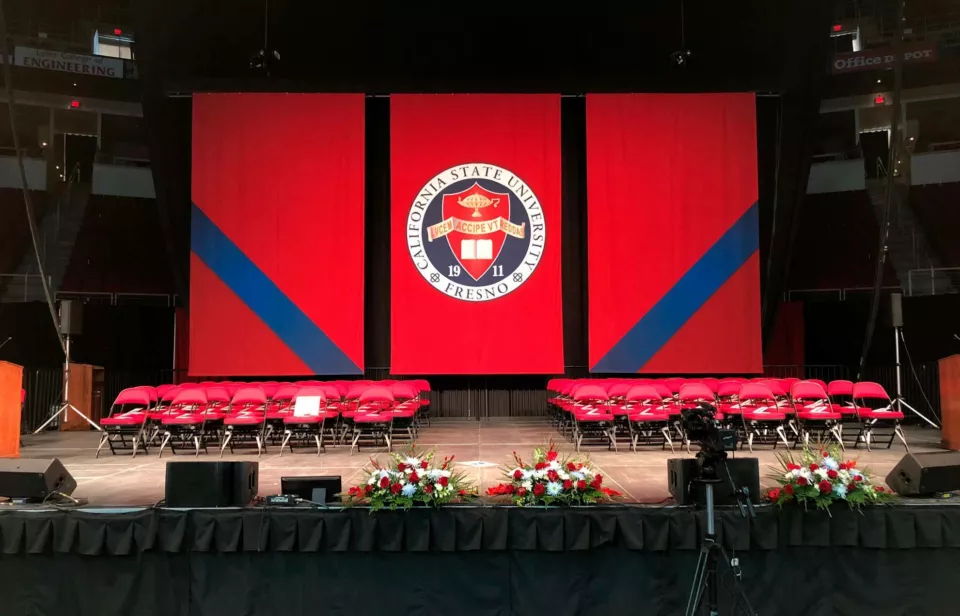 Auditorium stage banner for college graduation.