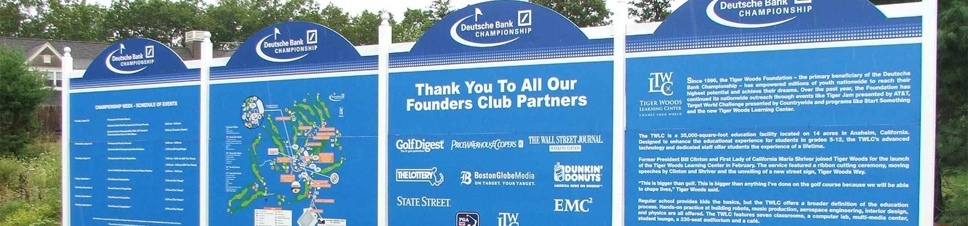 Wayfinding signage at a golf tournament featuring course information and sponsor logos.